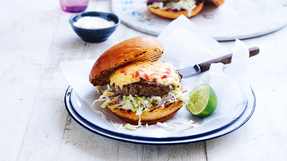 A Curtis Stone's southern-style cheeseburger and lemon wedges