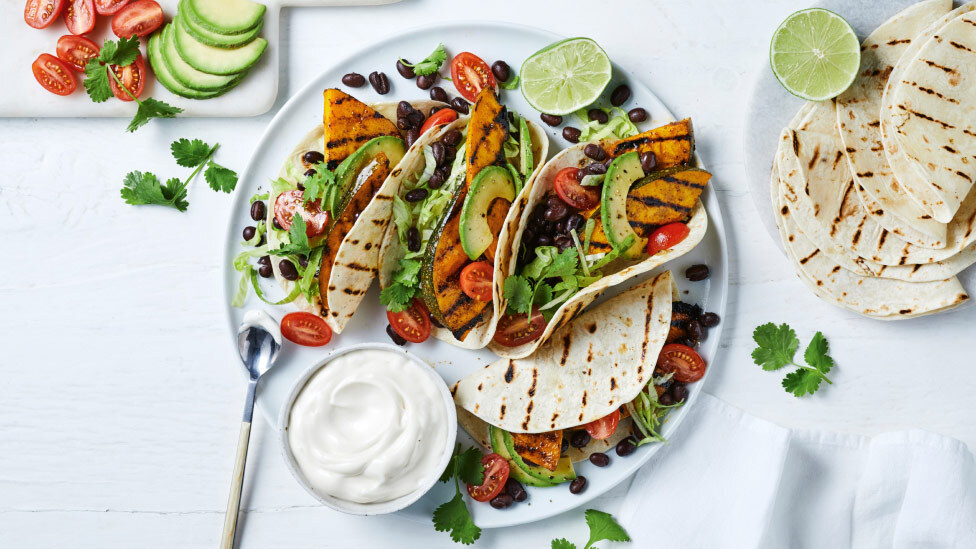 Four pumpkin and black bean taco wraps