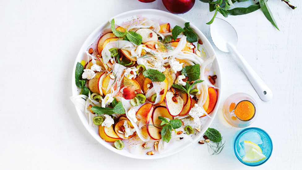 A bowl of Pickled nectarine, fennel and goat’s cheese salad with dressing