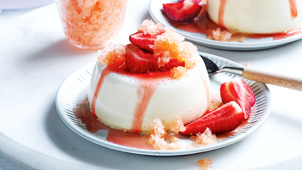 A vanilla panna cotta topped with strawberries and aperol ice