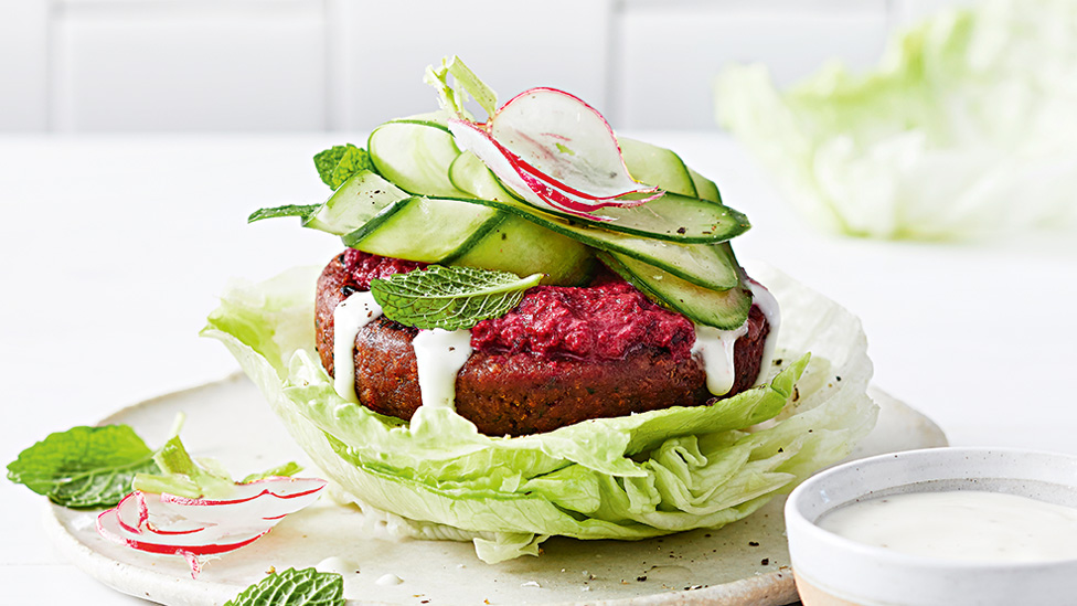 Vegan burger in lettuce bun and cucumber ribbons