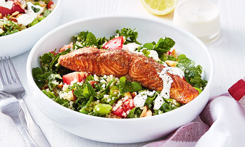 Quinoa salad topped with baked salmon