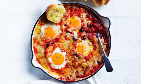 Four baked eggs with Mexican mixed beans and garlic bread