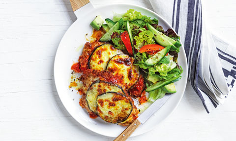A pork and eggplant parmiagian served with a simple salad