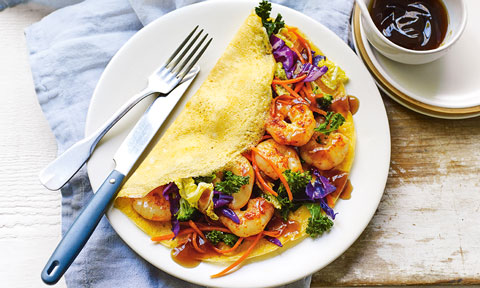 An omelette folded over with thai style proawns inside