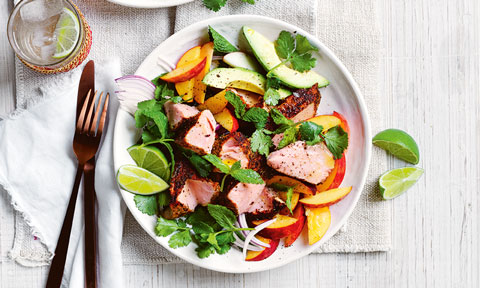 Blackened salmon with peach salad and lemon wedges