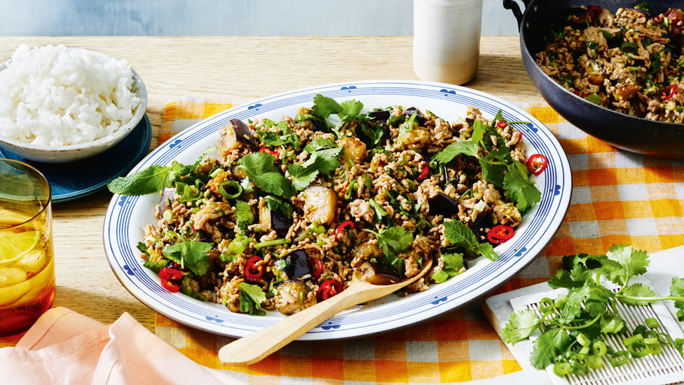 A plate of Vietnamese-style pork stir fry with mince meat, red chilli and herbs.