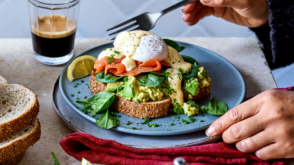 Smashed avo toast with poached eggs and hollandaise sauce