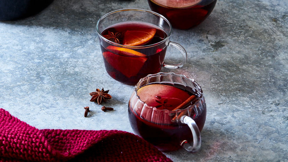 Glass of mulled wine with slice of apple