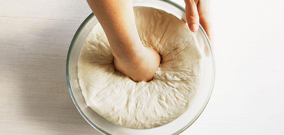Someone kneeding flour