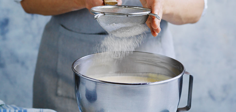 Someone sifting flour