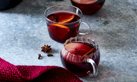 Glass of mulled wine with slice of apple