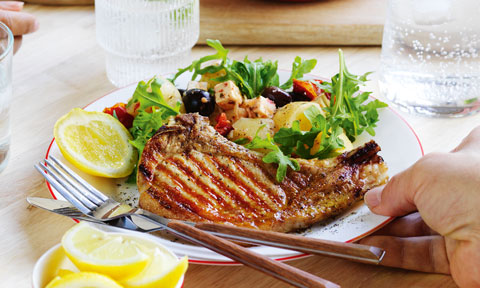 Chargrilled pork with antipasto potato salad