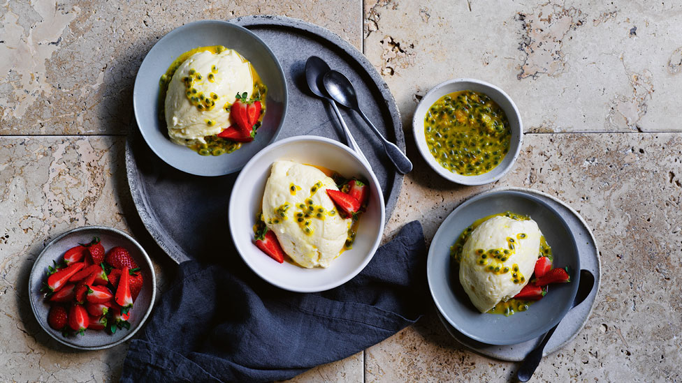 3 bowls of white chocolate mousse topped with strawberries and passionfruit