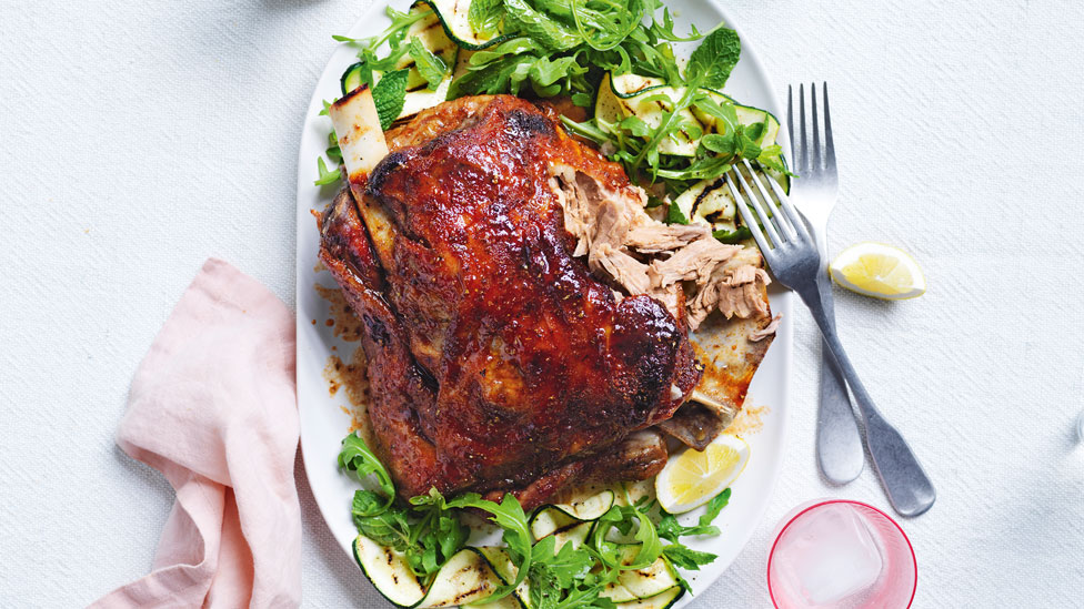 Slow-roasted maple and bourbon lamb shoulder with zucchini ribbons and salad leaves