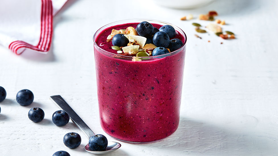 Dragon fruit smoothie topped with blueberries