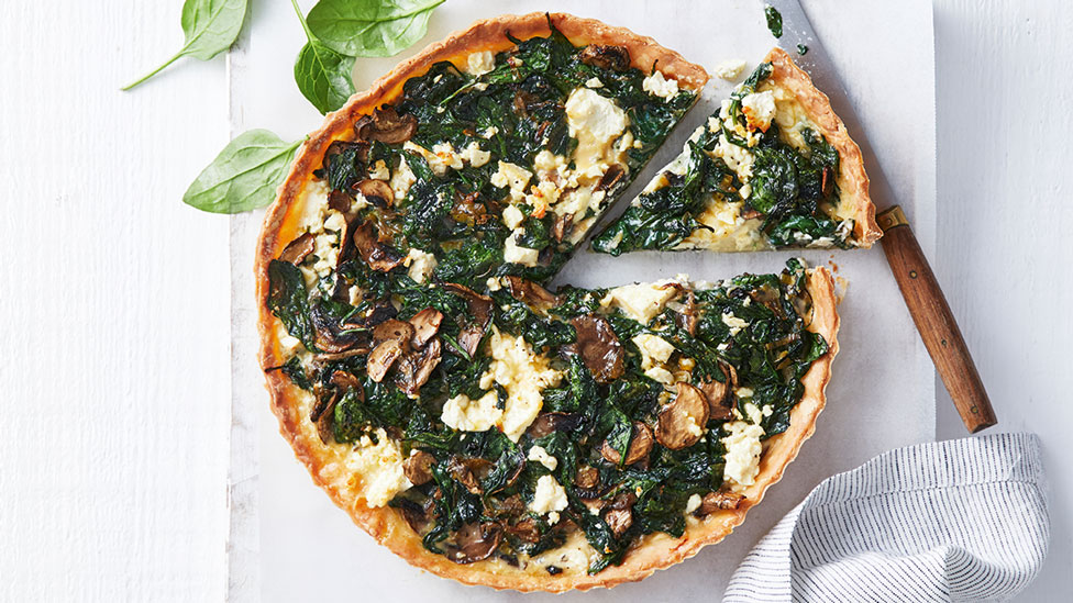 Gluten-free spinach and mushroom tart cut into wedges