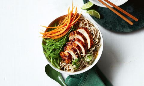 A bowl of spicy chicken ramen with garnishes