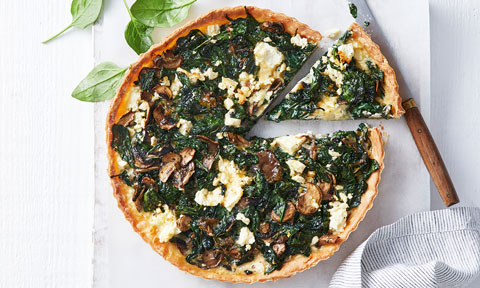 Gluten-free spinach and mushroom tart cut into wedges
