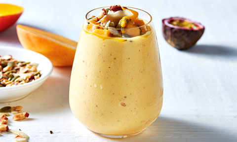 A cup of tropical mango and almond smoothie