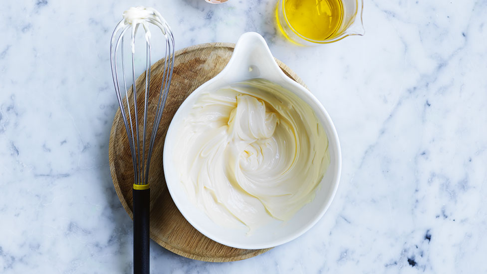 A small ceramic jar of mayonaise