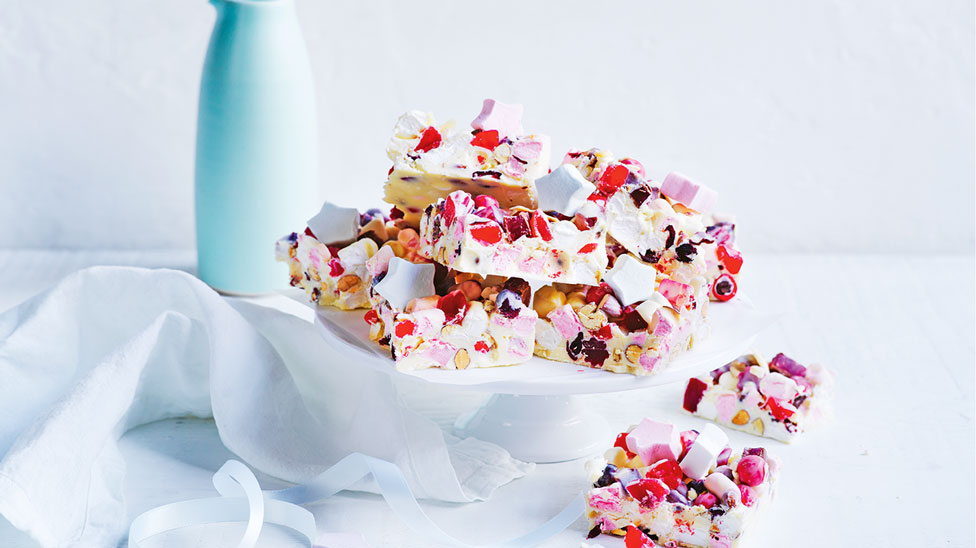 Bunch of white chocolate rocky road slices with marshmallow stars.