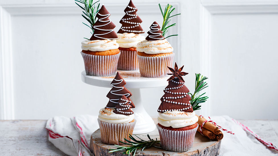 Gingerbread cupcakes with eggnog frosting, topped with gingerbread and twigs of pine