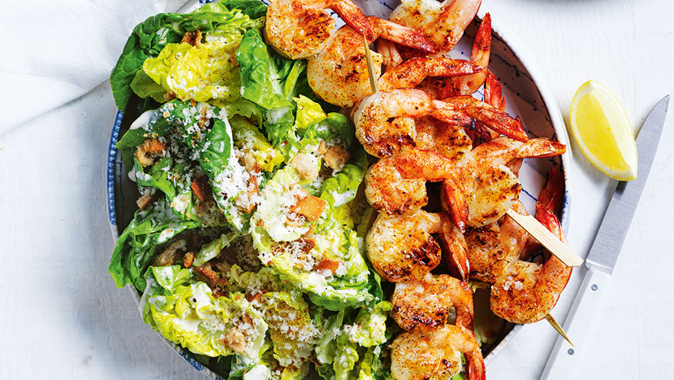 Prawns served on a bed of caesar salad topped with crouton crumbs