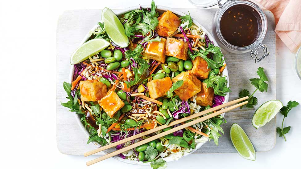 Salad mixture topped with Asian-style tofu cubes