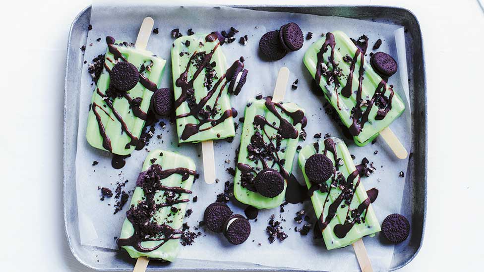 Six choc-mint cookies and cream ice blocks on a baking tray