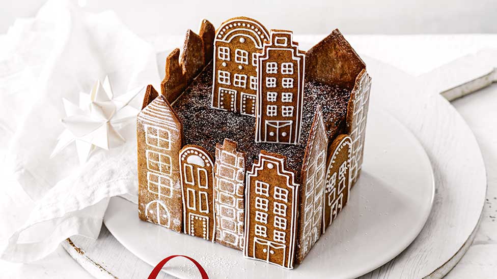 Christmas fruitcake surrounded with gingerbread into a city shape