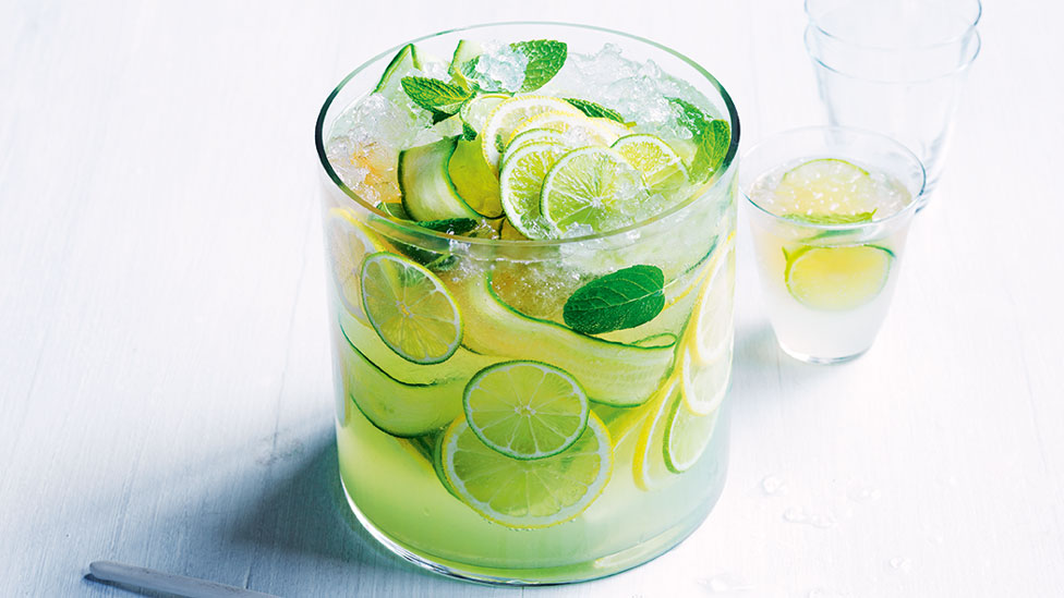 A glass of cucumber cooler with lemon and lime