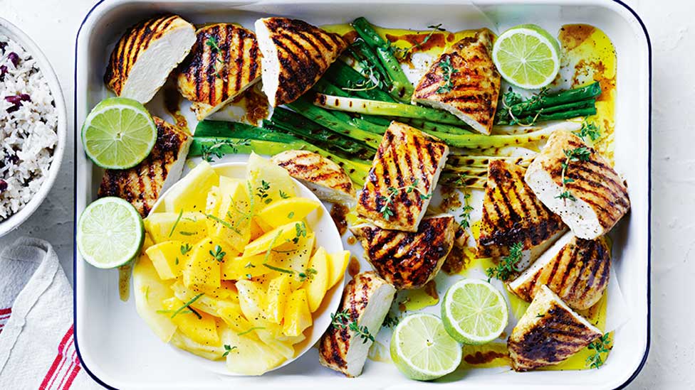 Jerk-style chicken chops with coconut rice and lime weges