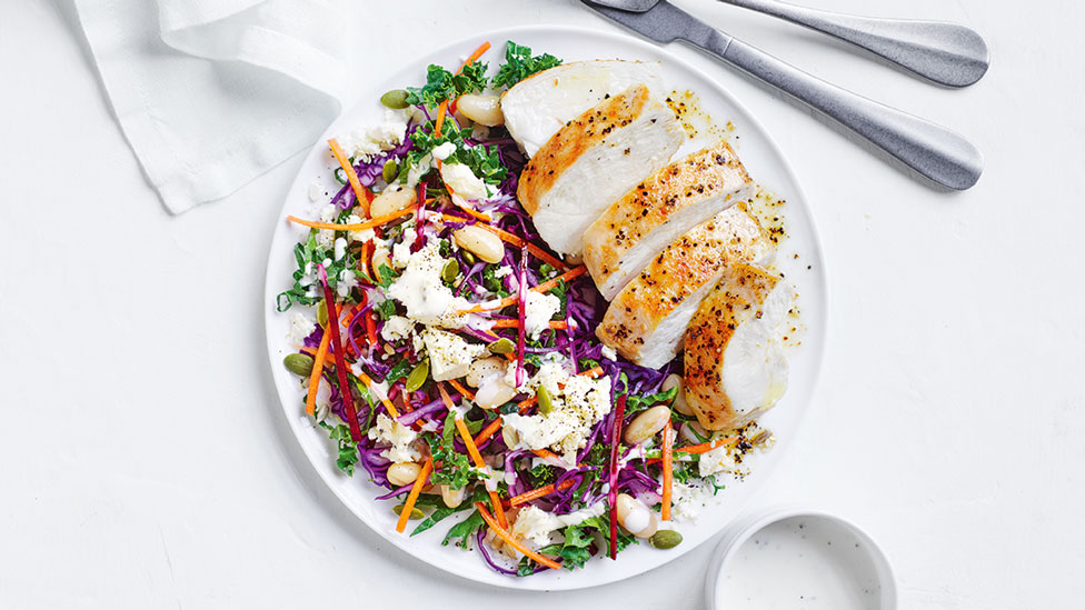 Lemon pepper chicken thickly sliced with kale and white bean slaw