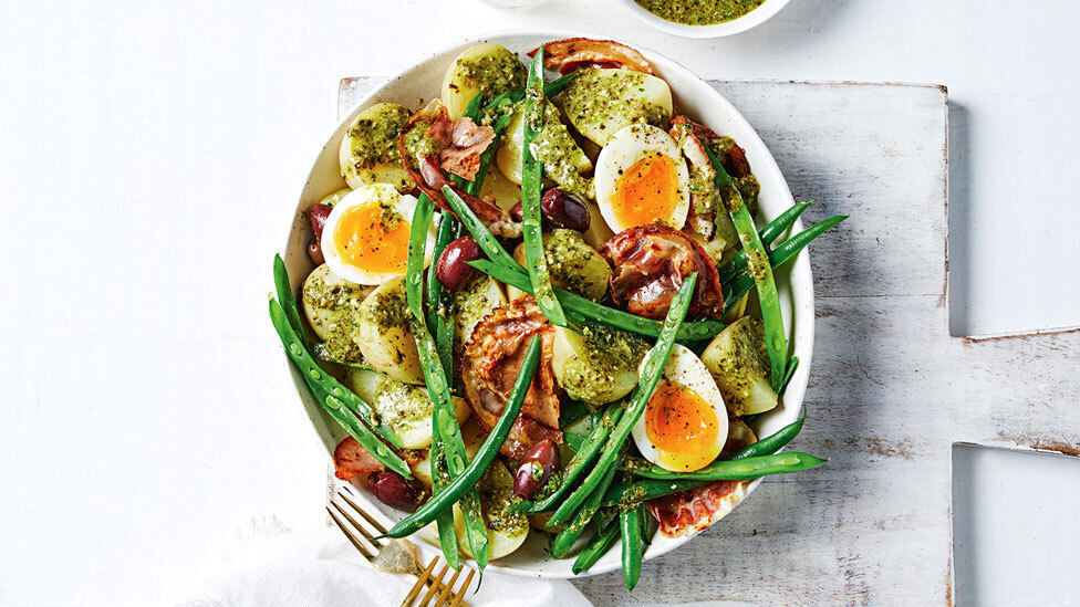 Potato salad with pesto, crispy pancetta and halved sofy-boiled eggs