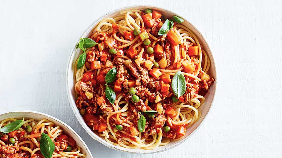 A bowl of spaghetti bolognaise with vegetable mixture