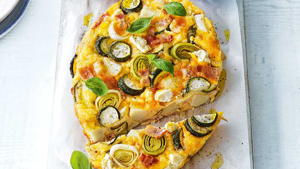 Zucchini, leek and potato frittata with bacon and tomatoes