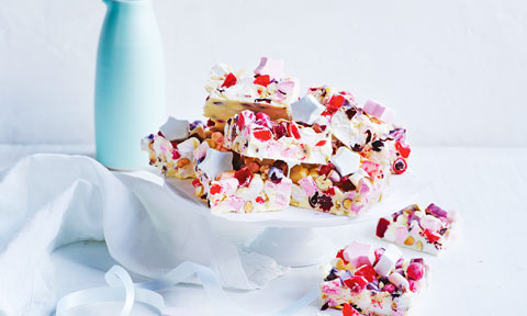 Bunch of white chocolate rocky road slices with marshmallow stars.