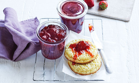 Two pots of home made strawberry jaw served with crumpets