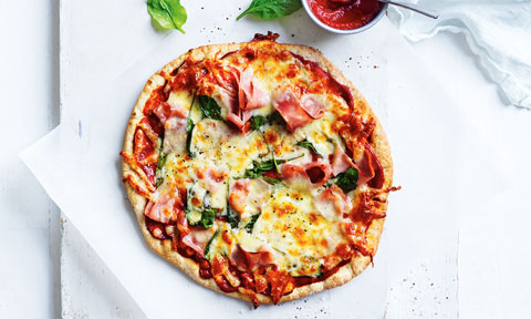 A spinach and ham pizza