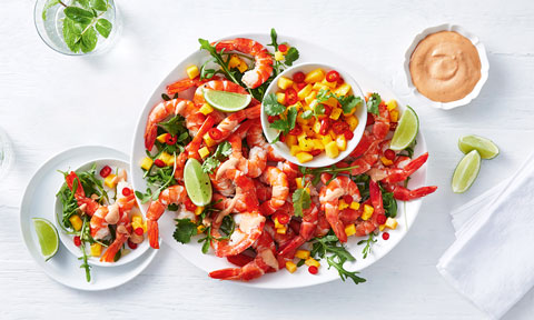 A tray of tiger prawns served with mango salsa