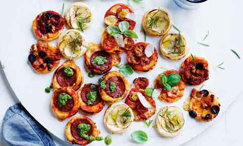 A table covered in mini antipasto pizzas