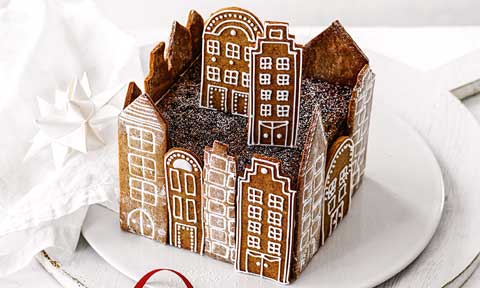 Christmas fruitcake surrounded with gingerbread into a city shape