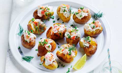 Mini jacket potatoes with sour cream, prawns and chives