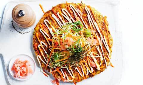 Pork and cabbage Japanese-style pancake dressed with traditional mayonnaise and sriracha mayonnaise.