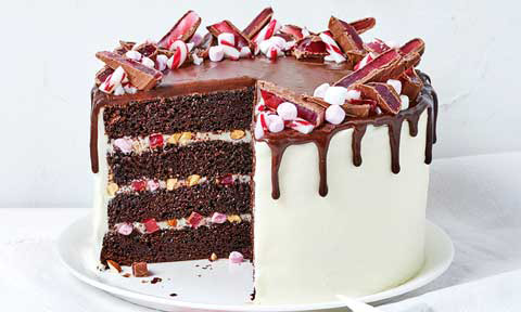 Rocky road Christmas layered cake topped with chocolate bars and marshmallows