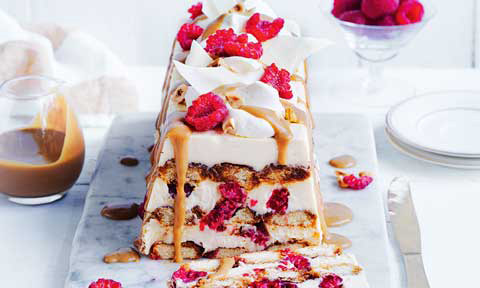 White chocolate and raspberry tiramisu topped with whipped cream and raspberries