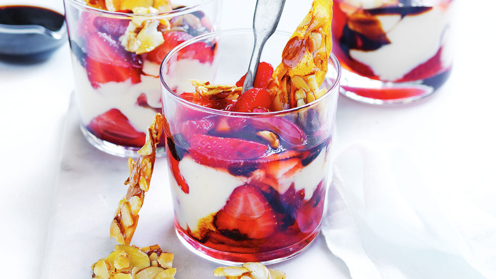 Three cups of Curtis' strawberry parfaits with balsamic syrup