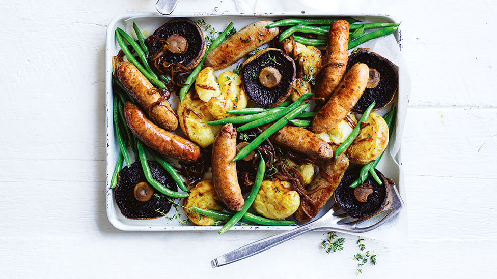 Bangers, flat mushrooms and smashed potato tray bake