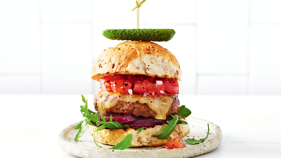 Beef burger with fresh tomato salsa and cucumber